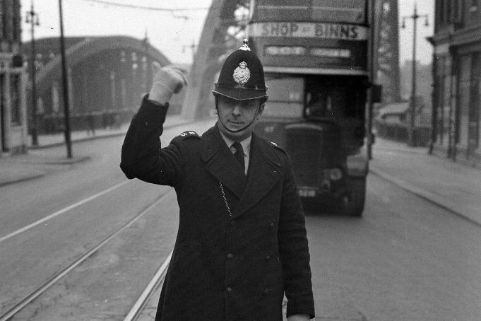 A police officer on duty and controlling the traffic in 1953.