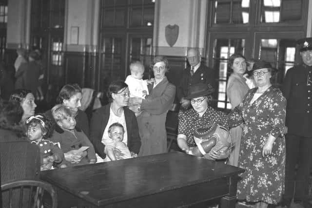 Women with  babies under two years of age receiving instructions how to use children's respirators - a 1939 scene in one of Sunderland's schools.
