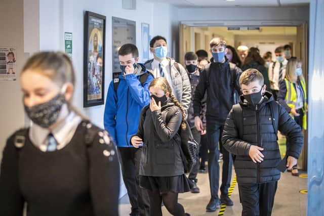 Students wear protective face masks as they head to lessons. Photo by PA.