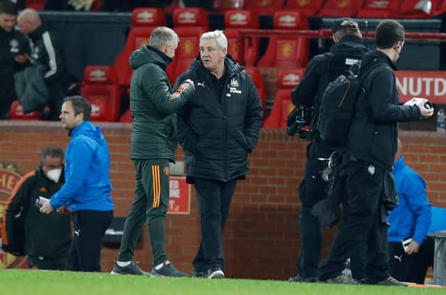 MANCHESTER, ENGLAND - FEBRUARY 21: Steve Bruce, Manager of Newcastle United interacts with Ole Gunnar Solskjaer, Manager of Manchester United after the Premier League match between Manchester United and Newcastle United at Old Trafford on February 21, 2021 in Manchester, England. Sporting stadiums around the UK remain under strict restrictions due to the Coronavirus Pandemic as Government social distancing laws prohibit fans inside venues resulting in games being played behind closed doors. (Photo by Phil Noble - Pool/Getty Images)