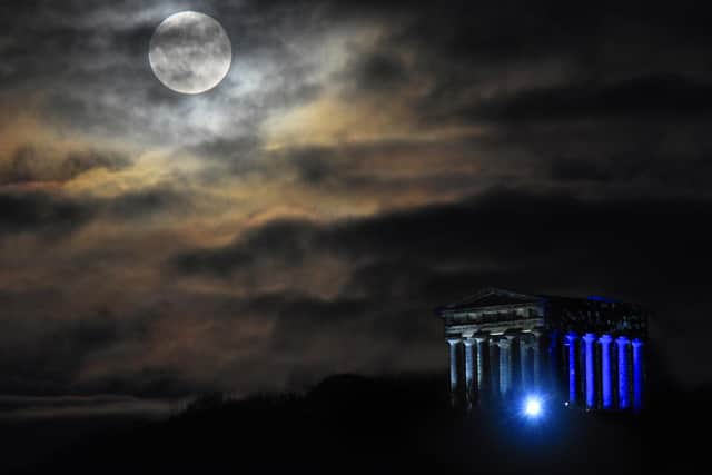 The Beaver moon rises over Penshaw Monument illuminated for Lumiere 2021 by “A Telling of Light” which transforms the Wearside landmark into a beautiful and haunting COVID-19 memorial .While this 18th century folly officially sits in Sunderland, it will be viewable for up to 20 miles  across County Durham. www.ianmacphotos.co.uk Ian McClellan