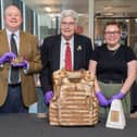 Victoria Howson, collections support officer at The Story, shows a set of medals to Colonel Ted Shields (left) and Councillor Adrian Schulman. Photo credit Tom Banks.