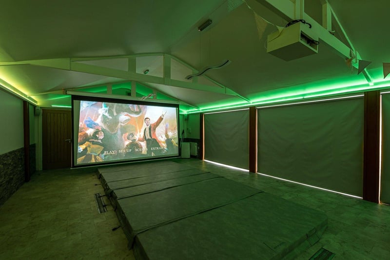 Alongside the pool, there is also a home cinema space which incorporates an electric projector and surround sound system, and a free standing wood burning stove.