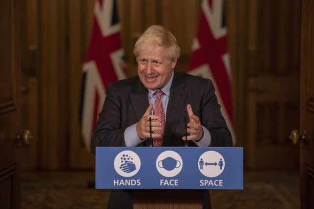Prime Minister Boris Johnston illustrating the safest distance between hands for the handshake.