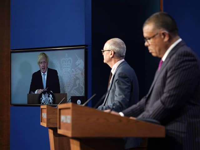 Prime Minister Boris Johnson appears on a screen from Chequers, where he is self-isolating, while chief scientific adviser Sir Patrick Vallance and deputy chief medical officer for England Professor Jonathan Van Tam speak from Downing Street, during a coronavirus briefing. Picture  by PA.