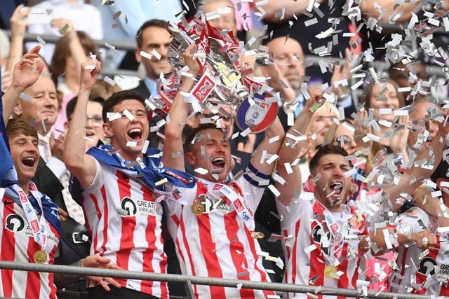 Corry Evans lifts the trophy as Sunderland secure promotion with a 2-0 win