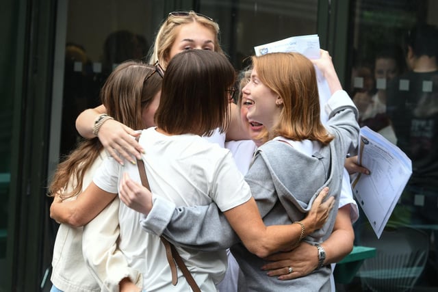 Pupils embrace as they celebrate their GCSE results.