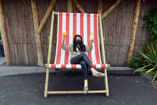 The Palm duty manager Steph Addison on a giant deckchair ahead of the opening of the man made beach