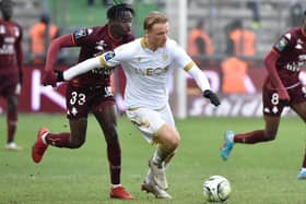 Metz's French defender Amadou Mbengue (L) fights for the ball with Nices Danish forward Kasper Dolberg during the French L1 football match between Metz (FC Metz) and Nice (OGCN) at the Saint-Symphorien stadium in Longeville-les-Metz, eastern France, on January 23, 2022. (Photo by Jean-Christophe Verhaegen / AFP) (Photo by JEAN-CHRISTOPHE VERHAEGEN/AFP via Getty Images)