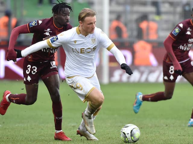 Metz's French defender Amadou Mbengue (L) fights for the ball with Nices Danish forward Kasper Dolberg during the French L1 football match between Metz (FC Metz) and Nice (OGCN) at the Saint-Symphorien stadium in Longeville-les-Metz, eastern France, on January 23, 2022. (Photo by Jean-Christophe Verhaegen / AFP) (Photo by JEAN-CHRISTOPHE VERHAEGEN/AFP via Getty Images)