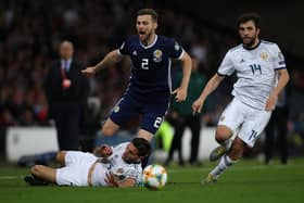 Stephen O'Donnell of Scotland vies with Magomed Ozdoev of Russia during a UEFA Euro 2020 qualifier.
