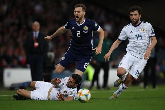 Stephen O'Donnell of Scotland vies with Magomed Ozdoev of Russia during a UEFA Euro 2020 qualifier.