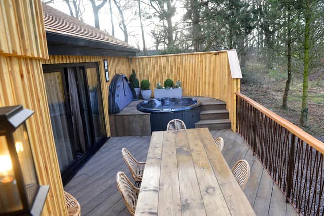 The tree houses include their own hot tubs and balcony areas.