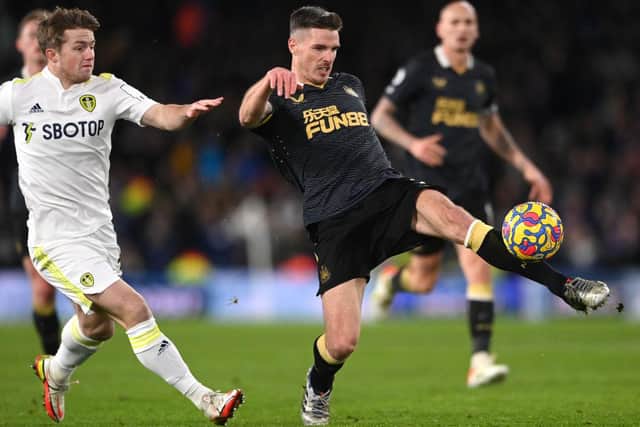 Newcastle defender Ciaran Clark (r) clears under pressure from Joe Gelhardt of Leeds during the Premier League match between Leeds United  and  Newcastle United at Elland Road on January 22, 2022 in Leeds, England. (Photo by Stu Forster/Getty Images)
