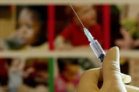 File photo of a nurse handling a syringe at a medical centre. Millions of parents in England are being urged to book their children in for missed measles, mumps, and rubella (MMR) jabs, amid a "very real risk" of measles outbreaks across the country. Officials said the decline in the uptake of routine childhood vaccinations is a "serious concern". Issue date: Monday January 22, 2024.