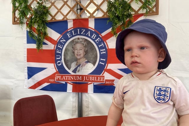 Remy Roberts, aged 18 months at the time, poses for a photograph with the Queen's flag at Seaham Cricket Club.