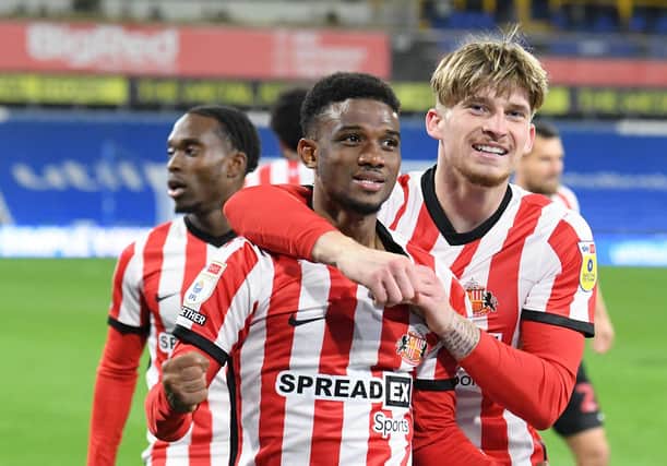 Amad Diallo, Dennis Cirkin and Jay Matete celebrate during Sunderland's Championship fixture at Huddersfield.
