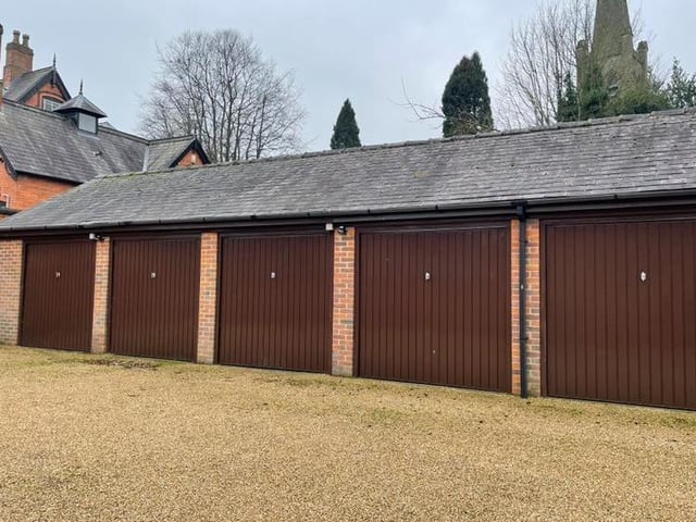 One of these double garages, with up-and-over doors and part of a separate block, will belong to the new owners of the Park Mews property for sale.