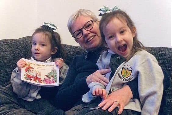 Suzanne Andrews with her identical twin granddaughters, Isla, left, and Freya, right.