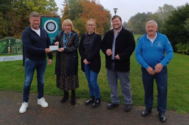 Sean Molyneux, left, vice-captain at George Washington Golf Club, with Sheelagh Taylor, of St Benedict’s Hospice; Walter Whitfield's daughter, Claire, son, Gavin, and Bill Michie, golf manager.