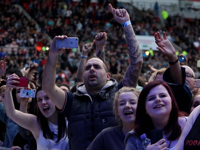 More cameras flash in the crowd.
