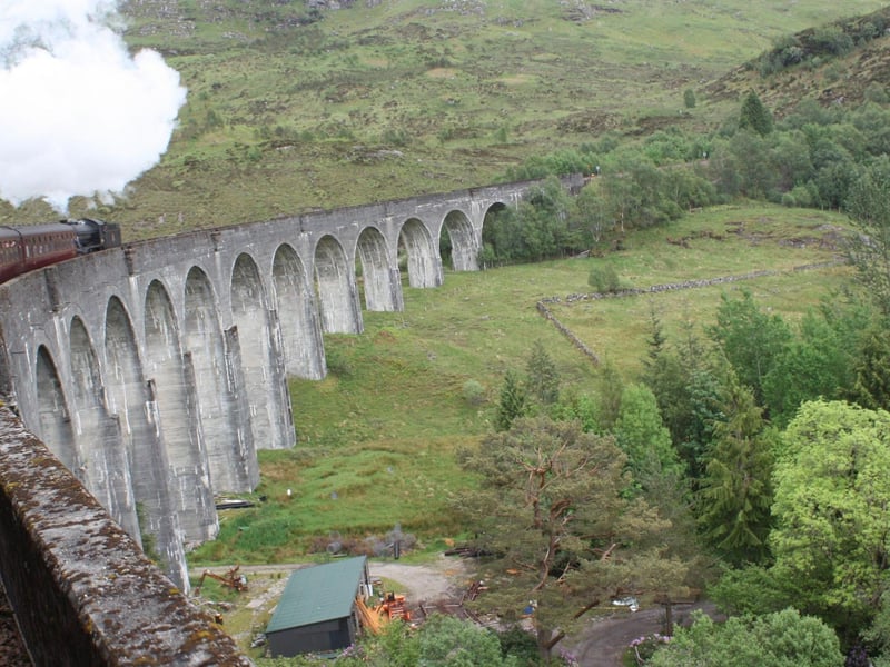 A train on the beautiful Glenfinnan Viaduct - made globally famous by the Harry Potter films.