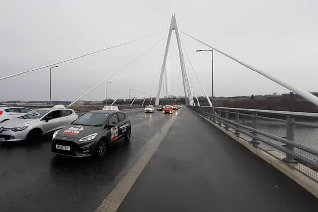 Driving instructors cross the Northern Spire Bridge in Sunderland as part of an earlier protest convoy against the closure of South Tyneside's driving test centre.