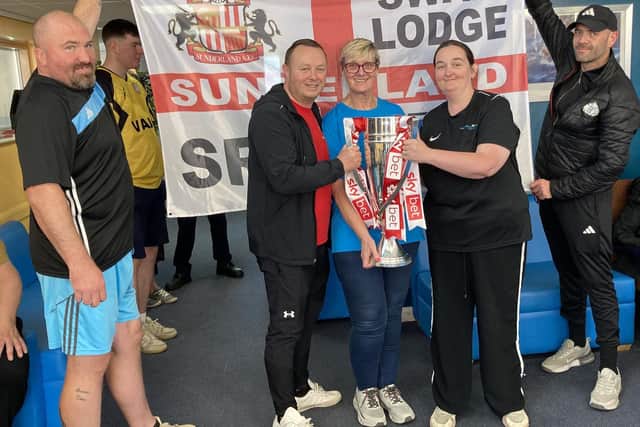 Staff and residents with the trophy