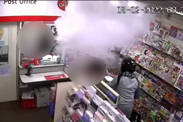 CCTV footage shows Syed Ahmed in a motorcycle helmet as the panic button causes a smoke cloud in a Post Office in Sunderland.