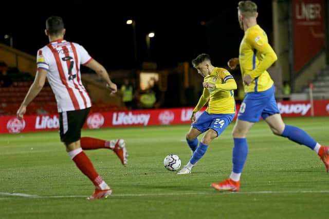 Dan Neil of Sunderland scores the first goal during the Papa John's EFL Trophy Group match between Lincoln City and Sunderland at Sincil Bank Stadium.