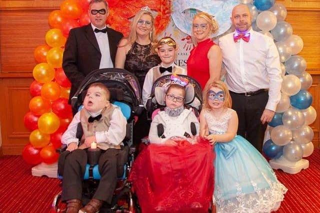 Claire Stewart and Amy Howes, founders of the Special Lioness charity with their families at a Special Lioness masquerade ball in 2019
