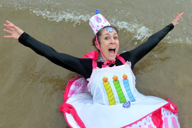 Taking a dip in style while dressed as a birthday cake. That's cool!