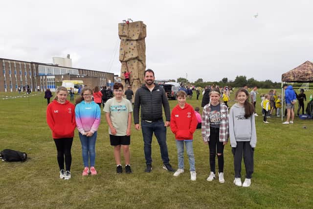 (left to right) Pupils Lucy Campbell, Emily Maddison, Jessica Marshland, Alex Russell, Lola Mawson and Neve Laws, all 11, and assistant headteacher Iain Buddle (centre).