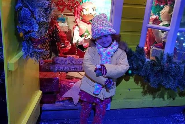 Estie Rose Henderson, 7, outside a sensory Christmas grotto similar to the one the charity plan to create. Estie is autistic and has a sensory processing disorder and high anxiety.