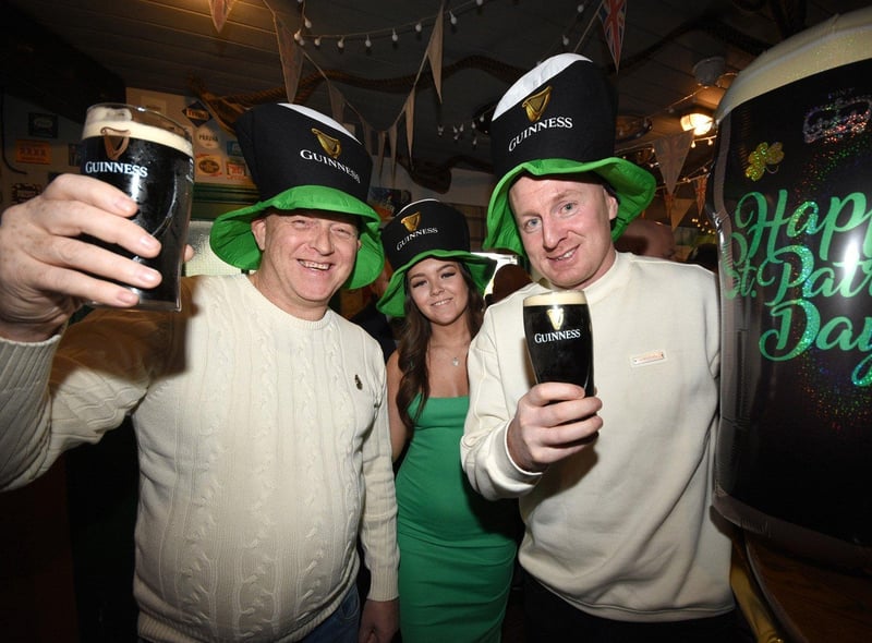 Saltgrass customers Paul Bennett, bar worker Edan Flanagan and Keith Graydon celebrate St Patrick's Day.