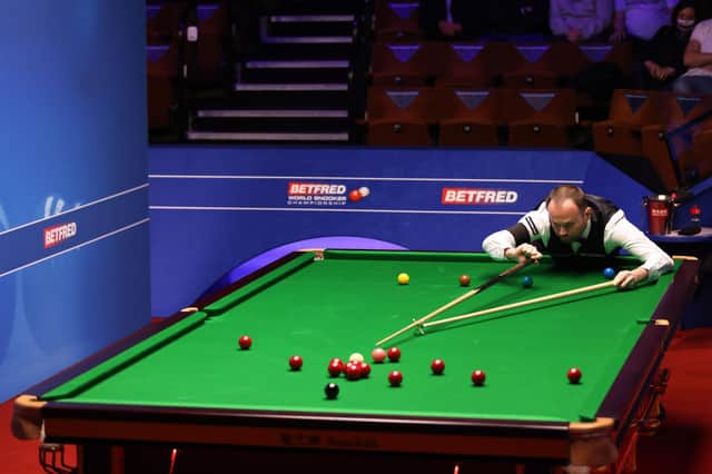Mark Joyce lines up a shot during the Betfred World Snooker Championships 2021. Picture by PA