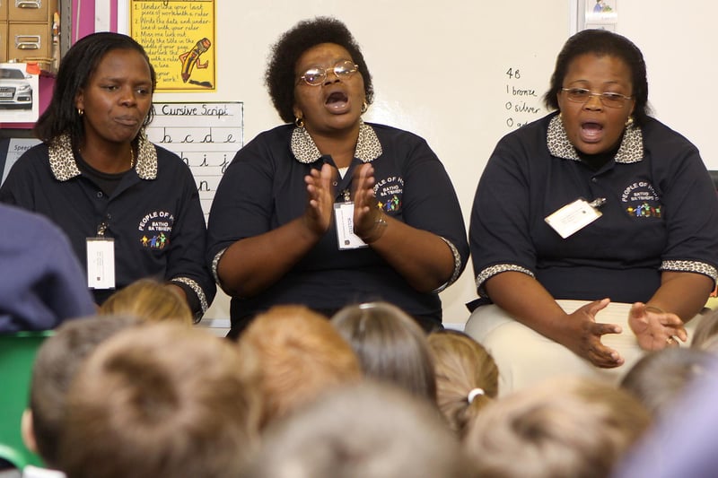 Miriam, Alice and Topsy from the People of Hope charity in Clarens, South Africa sing a traditional song to year four at Fairfield Endowed Junior School