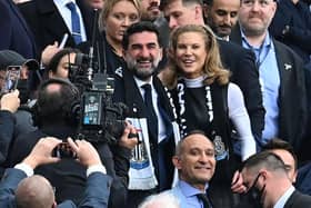 Newcastle United's Saudi Arabian chairman Yasir Al-Rumayyan (C) and Newcastle United's English minority owner Amanda Staveley (centre right) take their seats for the English Premier League football match between Newcastle United and Tottenham Hotspur at St James' Park in Newcastle-upon-Tyne, north east England on October 17, 2021. (Photo by PAUL ELLIS/AFP via Getty Images)