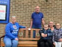 Sitting on the bench are Honest Boy manager Judith Pike, left, Bob Lindsay a family friend of the Walkers, Richard's sister Bage Walker and her children Rayne Kemp, two and Lexi Kemp, seven. Image, Sunderland Echo.