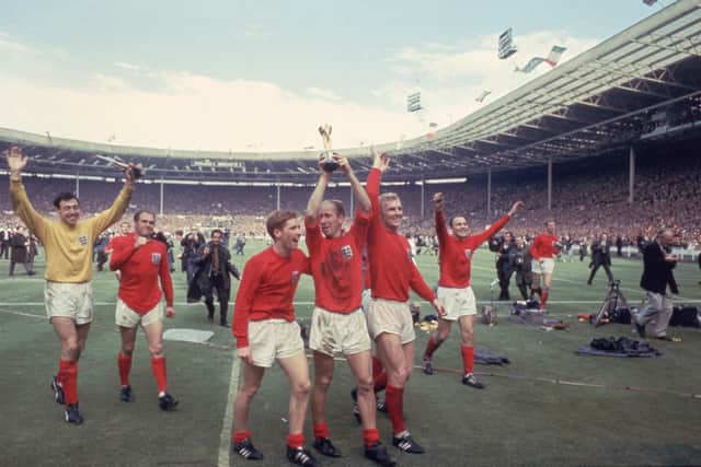 Bobby Charlton raises the Jules Rimet trophy in the air  following England's 4-2 victory after extra time over West Germany in the World Cup Final at Wembley Stadium, 30th July 1966. Amongst his team mates celebrating with him are goalkeeper Gordon Banks, Alan Ball on his right and team captain Bobby Moore (1941 - 1993) at his left. (Photo by Hulton Archive/Getty Images)