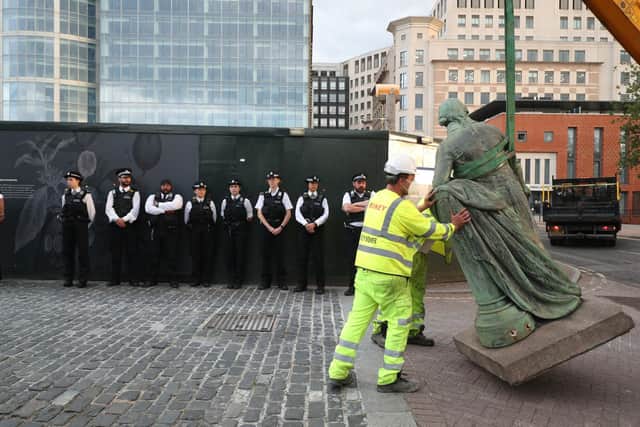 Workers take down a statue of slave owner Robert Milligan at West India Quay, east London as Labour councils across England and Wales will begin reviewing monuments and statues in their towns and cities, after a protest saw anti-racism campaigners tear down a statue of a slave trader in Bristol. Picture by Yui Mok/PA Wire