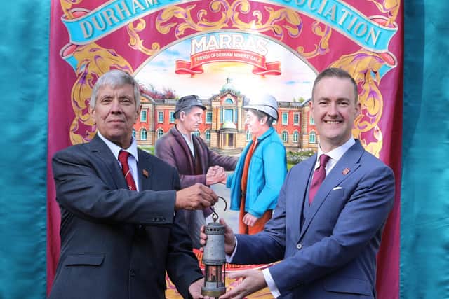 The DMA executive and representatives of the county’s banner groups at the Miners Hall as DMA Secretary Alan Mardghum passes the flame to Chris McDonald, Chair of Redhills CIO.
