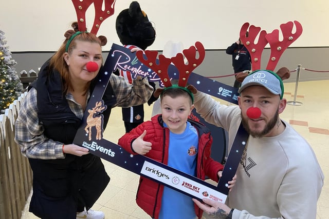Sonny Mitchinson with his dad Chris Mitchinson and mum Rachel Rocks, dressed in antlers and red noses ahead of the race.