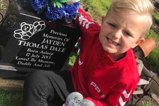 Thomas Dale at the graveside of his brother Jayden.