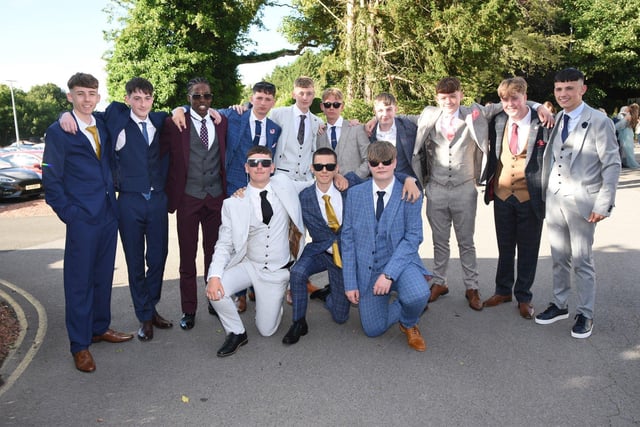 Year 11 boys pose for the camera in their suits.
