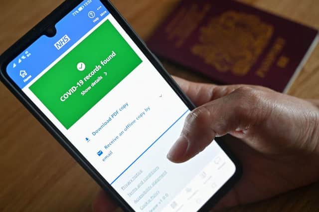 An illustration picture shows a smartphone screen displaying a Covid-19 vaccine record on the NHS app. Picture: Justin Tallis/AFP via Getty Images.