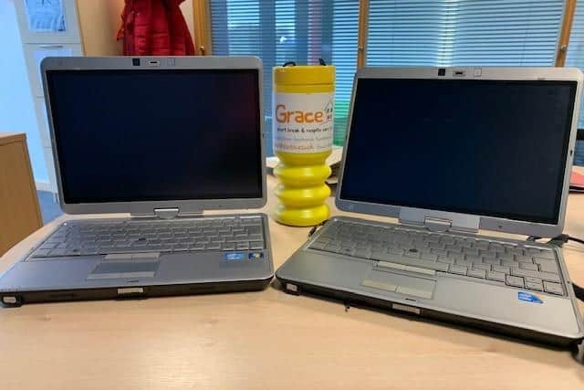 Two of the recycled laptops donated to Grace House.