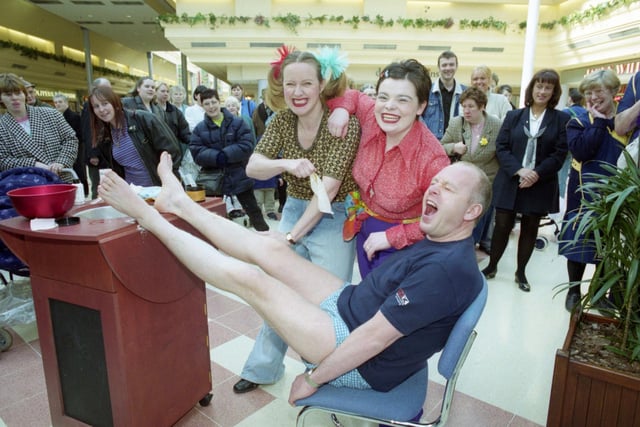 The Bridges Centre manager Kevin Rusby having his legs waxed by Body Shop staff in The Bridges. Trisha Divanis, left and Terri Morgan, right joined Kevin for this photo in 1999.