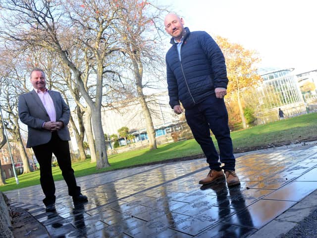 New stones are being laid at Mowbray Park Veterans' Walk. From left Rob Deverson and Tom Cuthbertson.