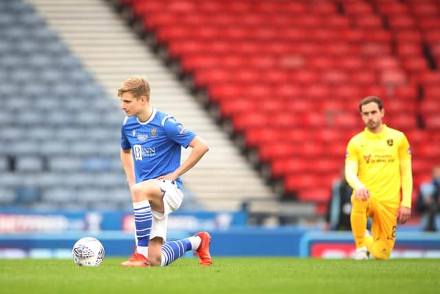Ali McCann of St Johnstone takes the knee ahead of the Betfred Cup final match between Livingston and St Johnstone at Hampden Park.